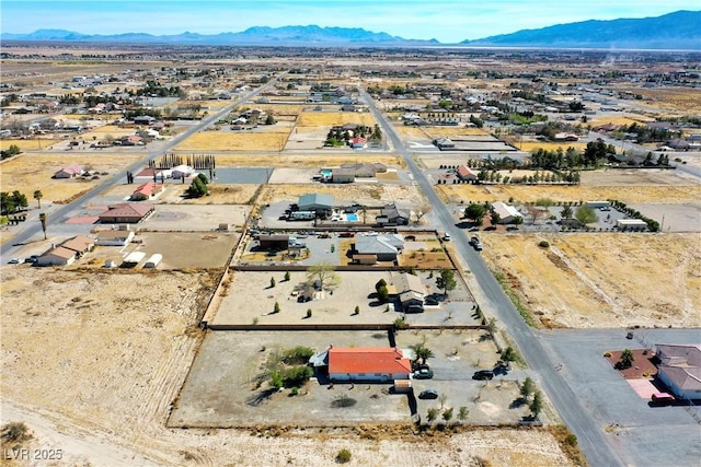 birds eye view of property with a mountain view and view of desert