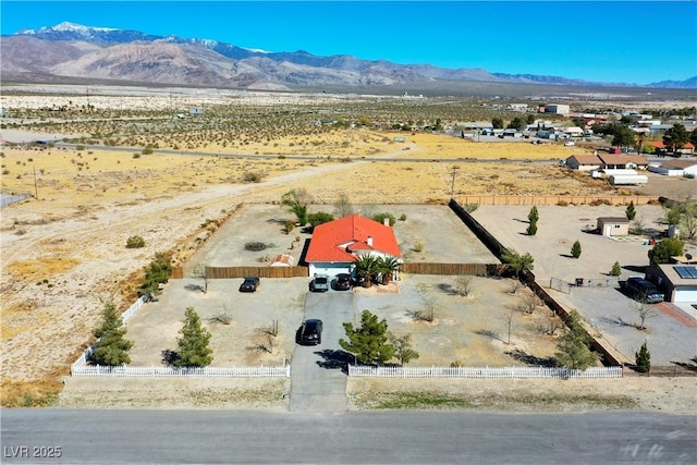birds eye view of property featuring a rural view, a mountain view, and view of desert