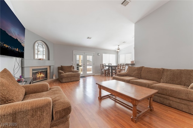 1010 Armillaria St, Henderson, NV 89011 - living room with visible vents, a tiled fireplace, wood finished floors, and lofted ceiling