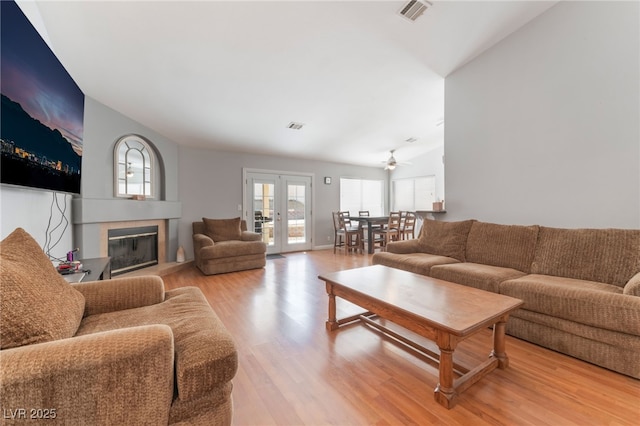 1010 Armillaria St, Henderson, NV 89011 - living area featuring a ceiling fan, a glass covered fireplace, light wood finished floors, and visible vents