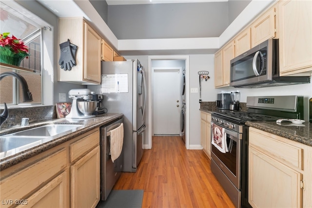 1010 Armillaria St, Henderson, NV 89011 - kitchen featuring a sink, light wood-type flooring, appliances with stainless steel finishes, and light brown cabinets