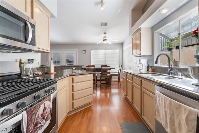 1010 Armillaria St, Henderson, NV 89011 - kitchen with visible vents, light wood finished floors, ceiling fan, appliances with stainless steel finishes, and a sink