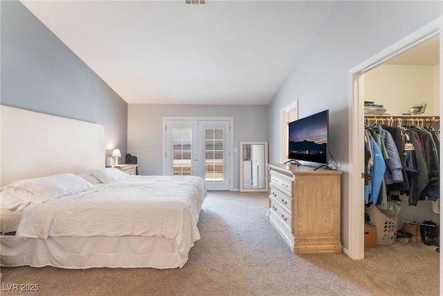 1010 Armillaria St, Henderson, NV 89011 - bedroom with french doors, a spacious closet, access to outside, lofted ceiling, and light colored carpet