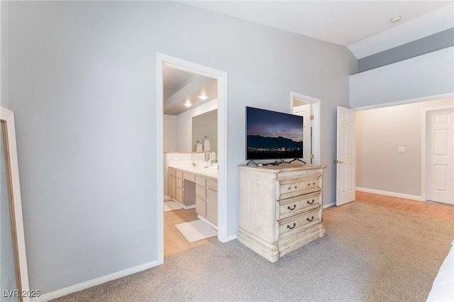 1010 Armillaria St, Henderson, NV 89011 - bedroom with light carpet, baseboards, and vaulted ceiling