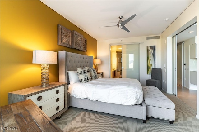 bedroom with a closet, a ceiling fan, connected bathroom, and visible vents