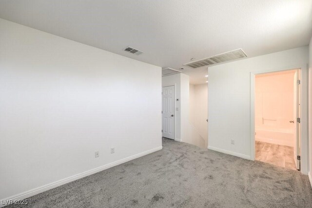 4516 Townwall St, Las Vegas, NV 89115 - spare room featuring attic access, carpet floors, baseboards, and visible vents