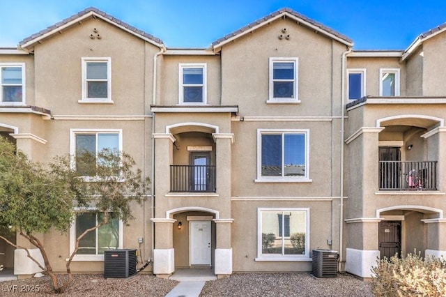 4516 Townwall St, Las Vegas, NV 89115 - view of property featuring stucco siding, central AC, and a tiled roof