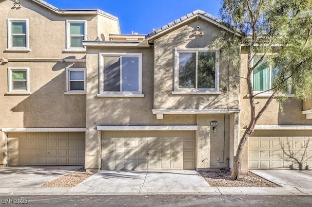 4516 Townwall St, Las Vegas, NV 89115 - townhome / multi-family property featuring driveway, stucco siding, and an attached garage