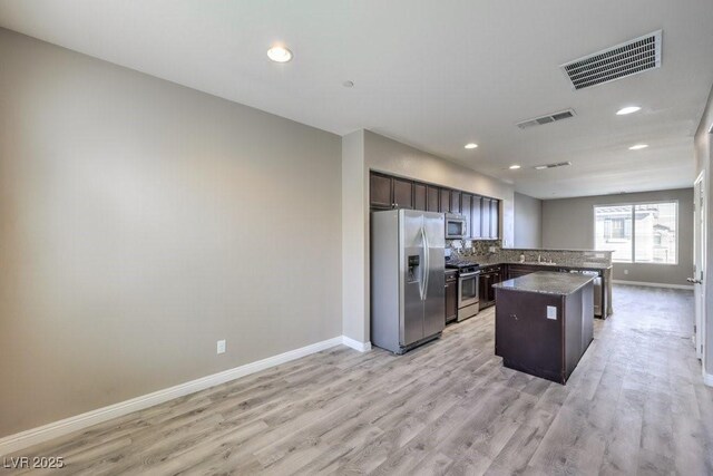 4516 Townwall St, Las Vegas, NV 89115 - kitchen with dark brown cabinets, baseboards, visible vents, and stainless steel appliances