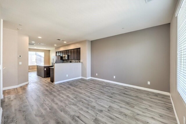 4516 Townwall St, Las Vegas, NV 89115 - unfurnished living room with recessed lighting, baseboards, light wood finished floors, and visible vents