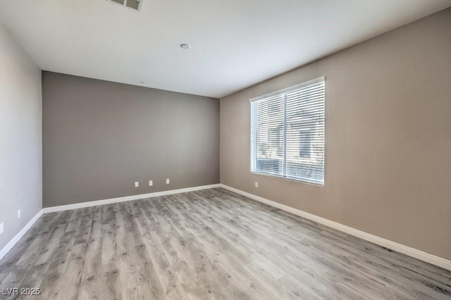 4516 Townwall St, Las Vegas, NV 89115 - spare room with baseboards, visible vents, and wood finished floors