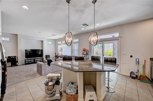 6516 Austin Hope Ave, Las Vegas, NV 89118 - kitchen with a chandelier, light tile patterned floors, a breakfast bar, healthy amount of natural light, and recessed lighting