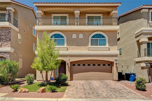 6516 Austin Hope Ave, Las Vegas, NV 89118 - view of front facade featuring a balcony, stucco siding, decorative driveway, and a garage