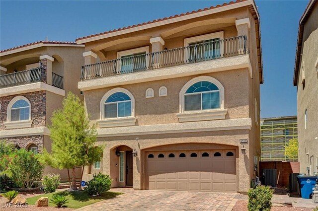 6516 Austin Hope Ave, Las Vegas, NV 89118 - view of front of property featuring stucco siding, an attached garage, a balcony, decorative driveway, and central AC