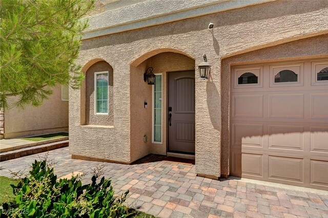 6516 Austin Hope Ave, Las Vegas, NV 89118 - doorway to property featuring stucco siding and a garage