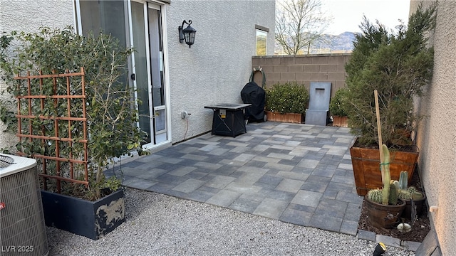 view of patio featuring central air condition unit and fence