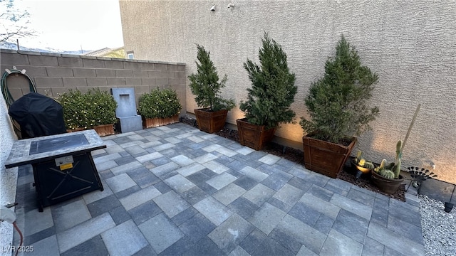 view of patio featuring fence and area for grilling