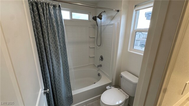 bathroom featuring shower / tub combo, toilet, and a healthy amount of sunlight