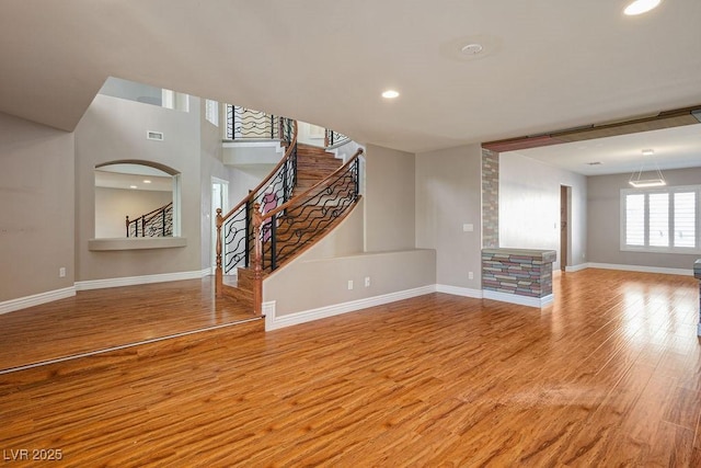 506 Staghorn Pass Ave, Las Vegas, NV 89183 - unfurnished living room featuring baseboards, wood finished floors, stairway, and recessed lighting