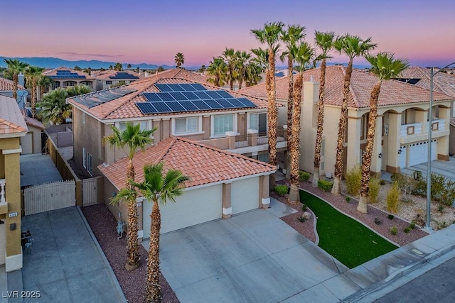 506 Staghorn Pass Ave, Las Vegas, NV 89183 - mediterranean / spanish home with a gate, a tiled roof, roof mounted solar panels, and stucco siding