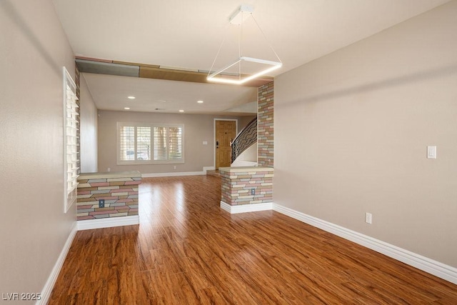 506 Staghorn Pass Ave, Las Vegas, NV 89183 - unfurnished living room featuring wood finished floors and baseboards