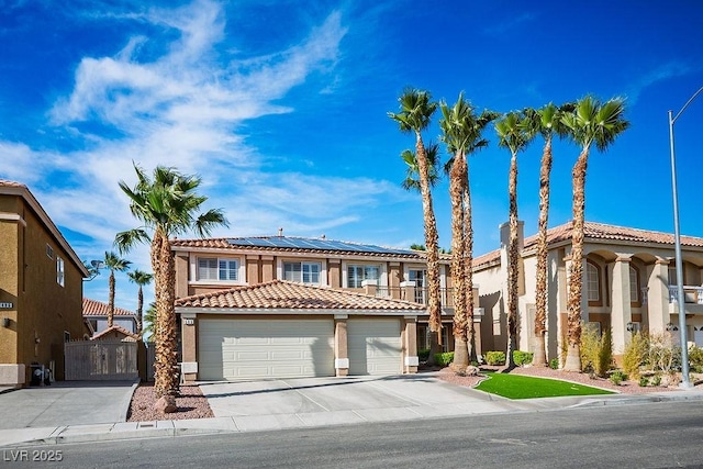506 Staghorn Pass Ave, Las Vegas, NV 89183 - view of front of home featuring a tiled roof, stucco siding, solar panels, driveway, and a garage