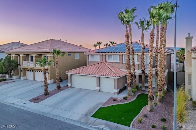 506 Staghorn Pass Ave, Las Vegas, NV 89183 - mediterranean / spanish home with concrete driveway, stucco siding, a tiled roof, and a balcony
