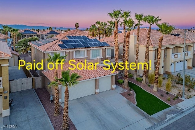 506 Staghorn Pass Ave, Las Vegas, NV 89183 - mediterranean / spanish-style house with a gate, a garage, a tiled roof, and stucco siding