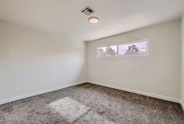 unfurnished room with baseboards, carpet floors, and visible vents