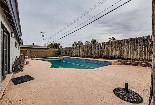 view of swimming pool with a fenced backyard, a patio, and a fenced in pool
