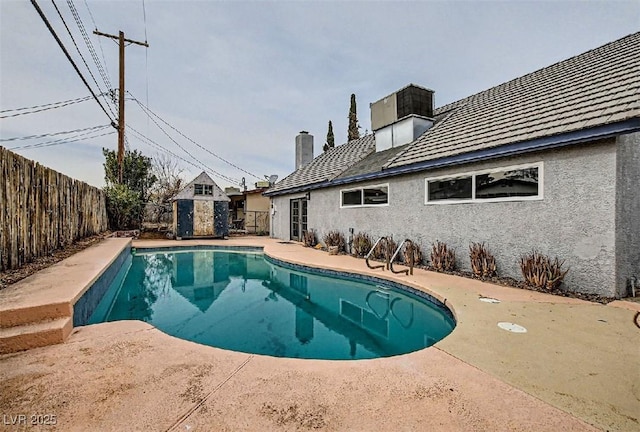view of swimming pool with a patio, a fenced in pool, and a fenced backyard