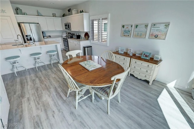 dining space with light wood-style flooring