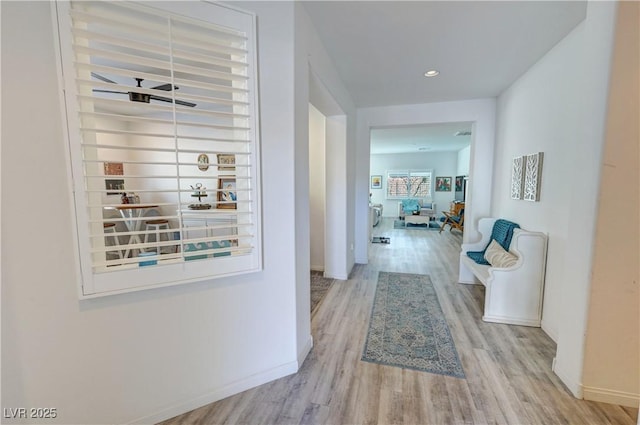 hallway with baseboards, wood finished floors, and recessed lighting