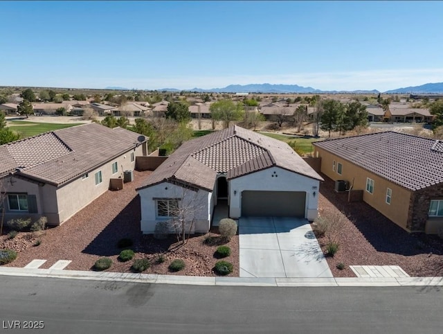 drone / aerial view featuring a residential view and a mountain view