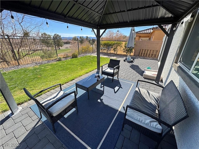 view of patio featuring a fenced backyard, an outdoor living space, and a gazebo