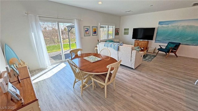 dining area with visible vents and light wood-style floors