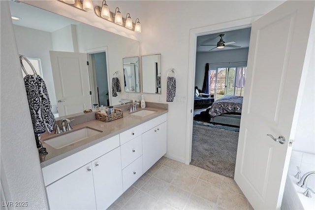 full bathroom with ensuite bathroom, double vanity, ceiling fan, and a sink