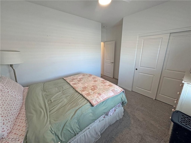 carpeted bedroom featuring a closet and a ceiling fan