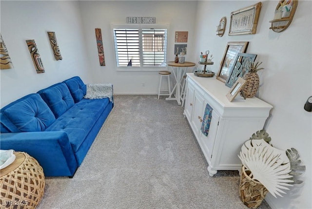 living area featuring carpet floors and baseboards