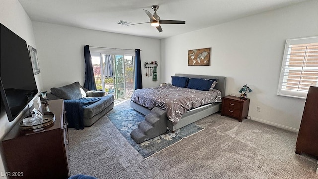 carpeted bedroom with baseboards, access to exterior, visible vents, and a ceiling fan