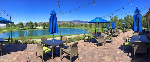 view of patio with outdoor dining space and a water view