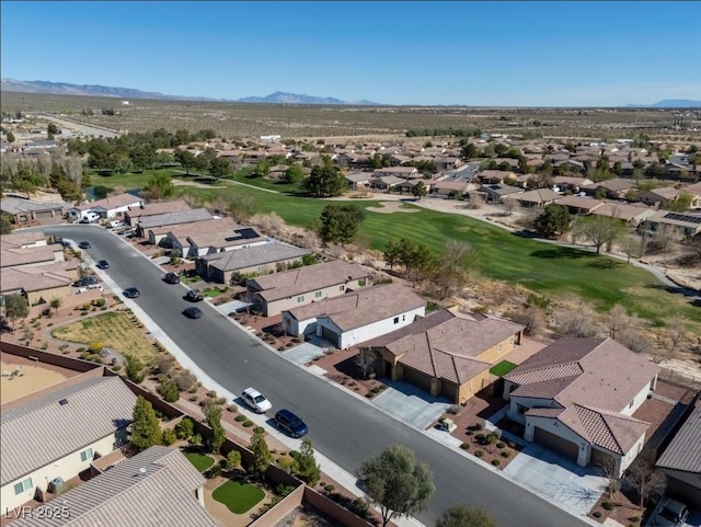 drone / aerial view with a residential view, golf course view, and a mountain view