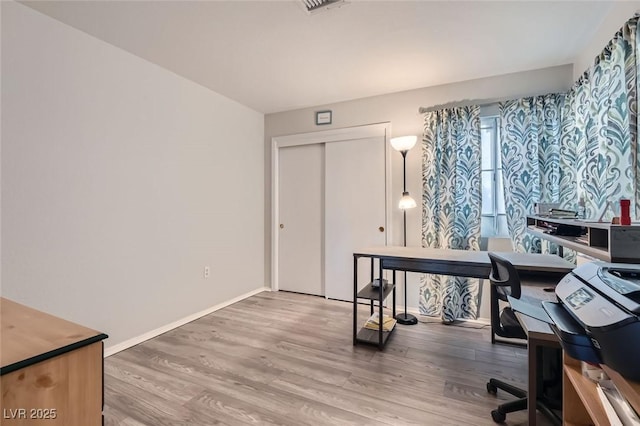 8628 Desert Holly Dr, Las Vegas, NV 89134 - home office with baseboards and wood finished floors