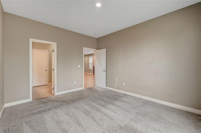 unfurnished bedroom featuring baseboards and carpet floors