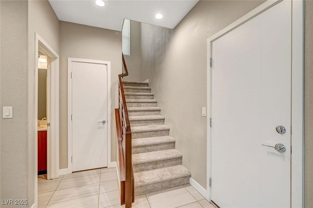 stairway with recessed lighting, tile patterned floors, and baseboards