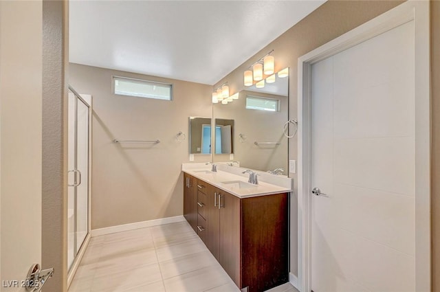 bathroom featuring a sink, tile patterned flooring, double vanity, and a stall shower