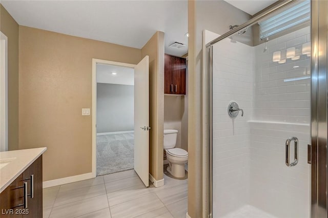 full bathroom with vanity, tile patterned flooring, toilet, a stall shower, and baseboards