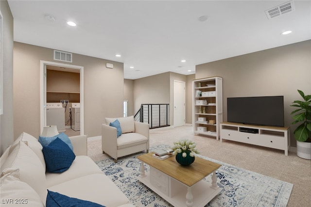 carpeted living room with visible vents, washer and clothes dryer, recessed lighting, and baseboards
