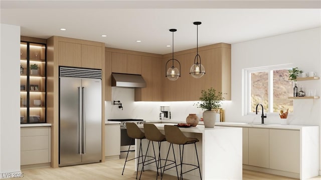 kitchen featuring light countertops, a sink, electric range oven, exhaust hood, and built in fridge