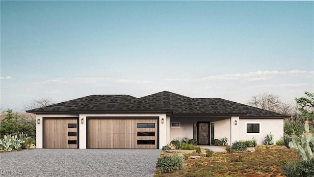view of front of home with stucco siding, driveway, a garage, and roof with shingles